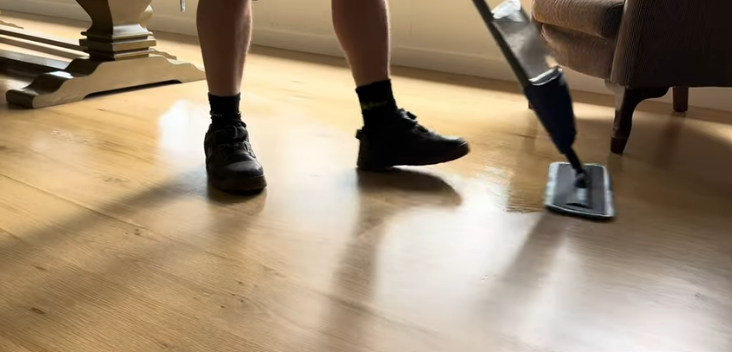 cleaning timber floor with a spray mop