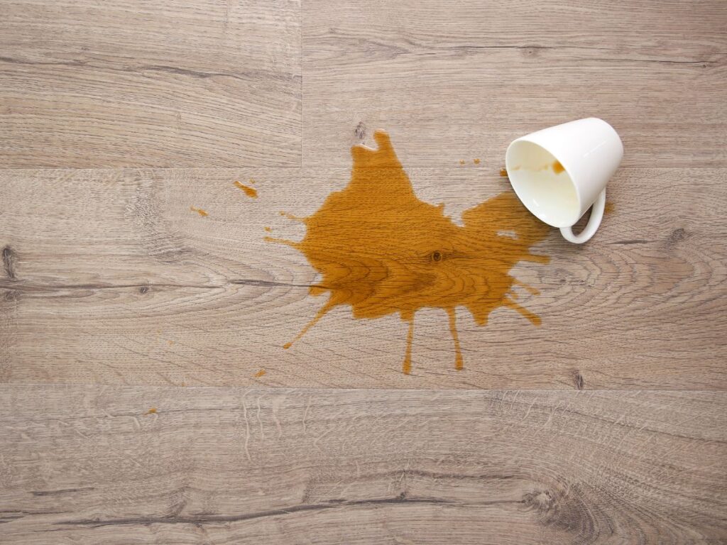 coffee that has been spilt on a wooden floor