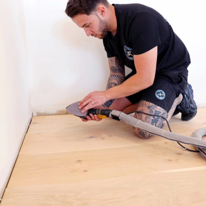 JP Timber Floor staff holding a sanding machine head